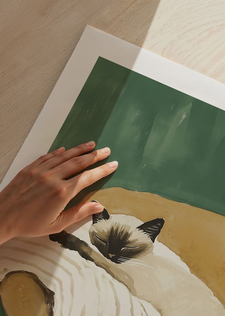 A poster of a sleeping Siamese cat on a striped blanket in a brown armchair-12