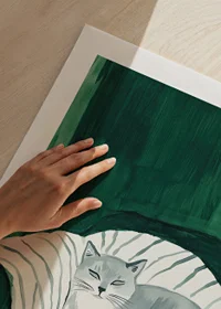 A poster with a gray cat resting on a striped blanket in a green armchair-9