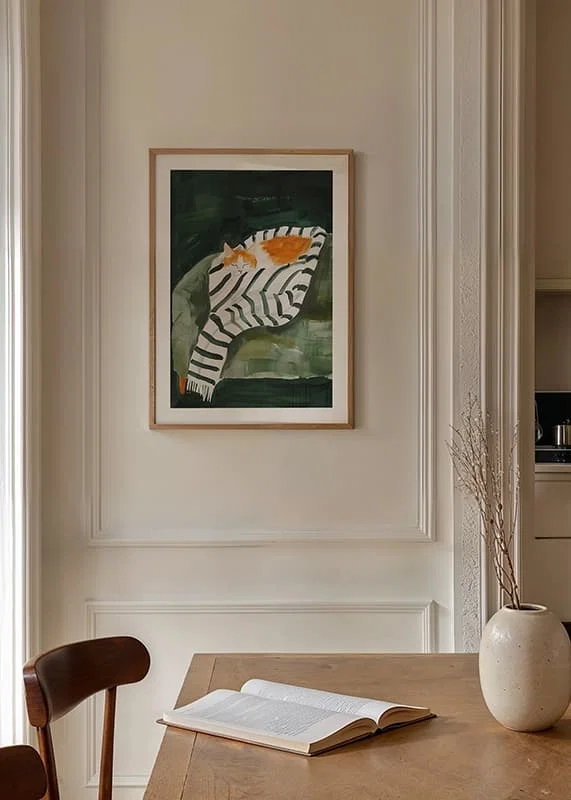 A poster of a sleeping orange cat wrapped in a striped blanket-12