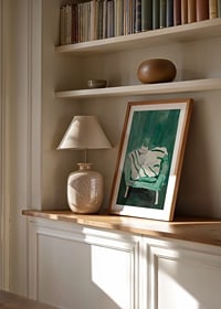 A poster of a white cat in a green armchair, giving the room a modern and artistic touch-8