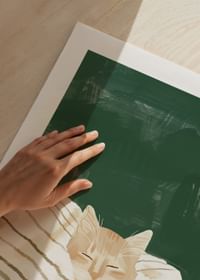 A poster of a resting orange cat under a striped blanket-5