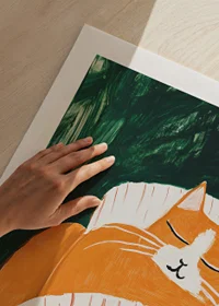 A poster of a sleeping orange cat under a striped blanket-9