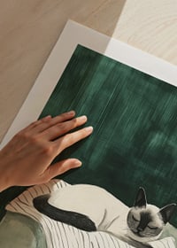 A poster of a Siamese cat resting on a striped blanket-9