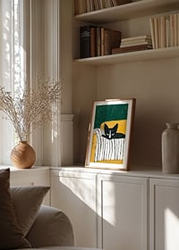 A poster of a black and white cat on a striped blanket-8