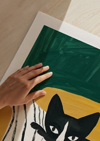 A poster of a black and white cat on a striped blanket-9