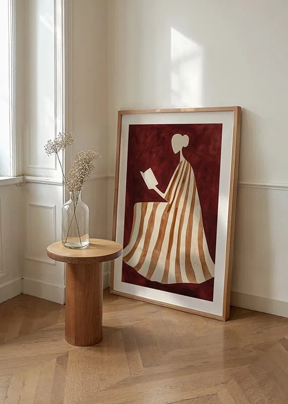 A poster depicting a reading figure in a striped dress against a warm, deep red background-12