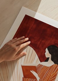 A poster of a woman in a striped dress reading a book -9