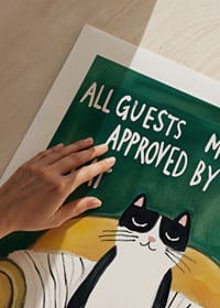 A poster of a cat in an armchair-9