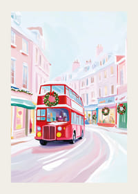 A poster of a red double-decker bus driving through a snowy, Christmas-decorated city-3