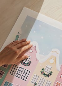 A poster with colorful houses decorated for Christmas-9