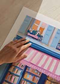 A poster of a colorful bookstore with a pink bicycle-9