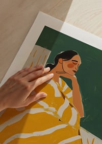 A poster of a woman in a yellow striped blanket-9