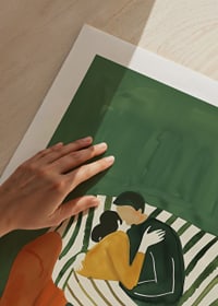 A poster of a couple in a loving embrace on an orange sofa-9