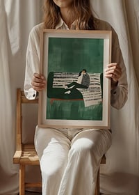 A poster of a couple sitting close together on a green sofa-8
