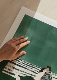 A poster of a couple sitting close together on a green sofa-9
