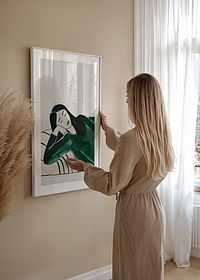 A poster depicting a woman in deep rest, wrapped in soft green tones-4