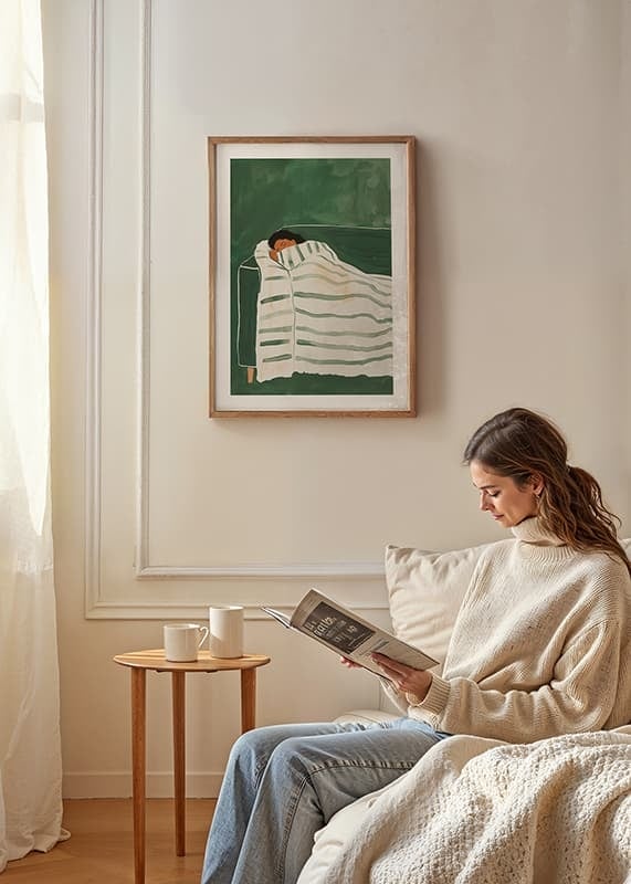 A poster depicting a person wrapped in a striped blanket, resting peacefully on a green sofa-12