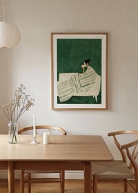 A poster depicting a woman wrapped in a striped blanket, enjoying a hot cup of-8
