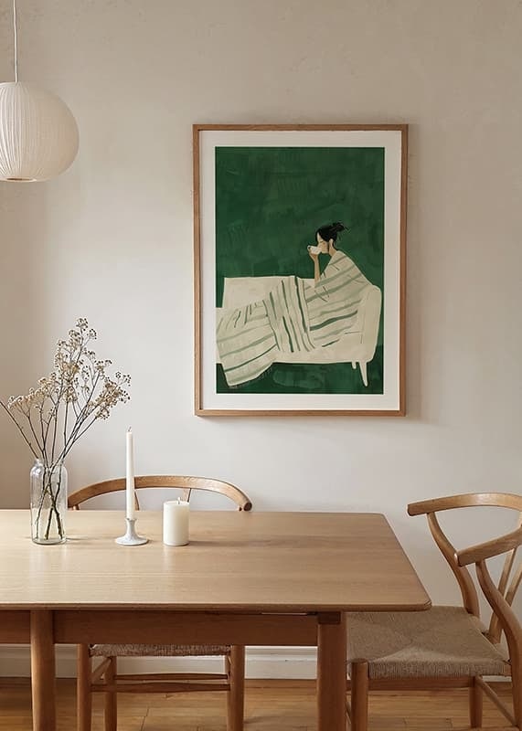 A poster depicting a woman wrapped in a striped blanket, enjoying a hot cup of-12