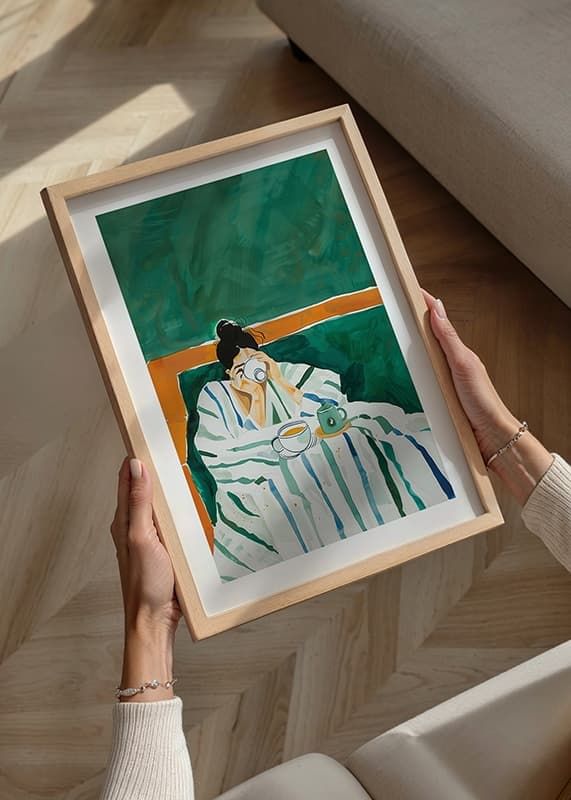A poster depicting a woman wrapped in a striped blanket enjoying a cup of coffee-12