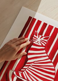 A tabby cat blends with red and white stripes in a playful pattern-9