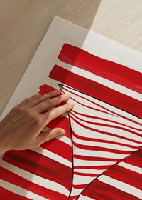 An elegant cocktail glass silhouette stands out against bold, red stripes-9