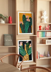 Colorful cactus blossom against a warm orange background spreads joy-8