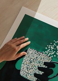A silhouette hand holding a magic cup on a deep green background-9