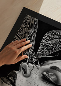 A dreamy moth kisses a face in black and white mystery-9